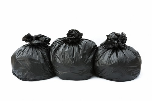 Waste collection trucks in South London streets